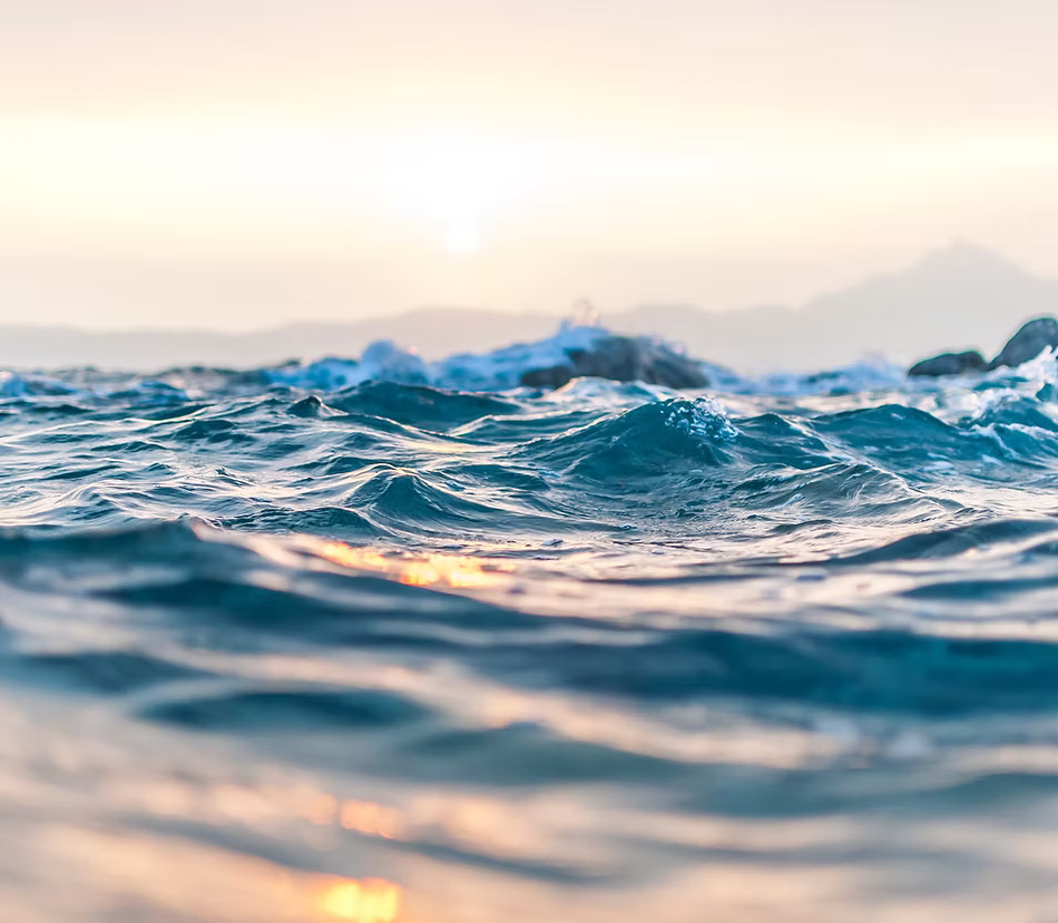 ocean waves and sky scene with the reflection of the sun on the water